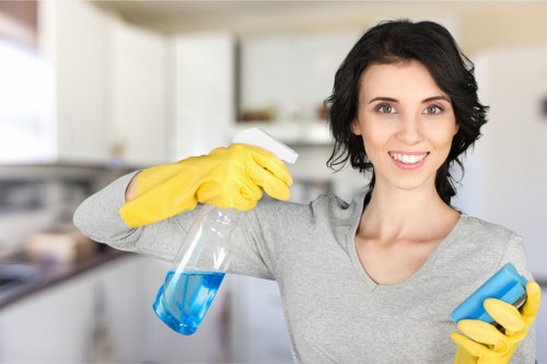 Technician cleaning a built-in oven in E2