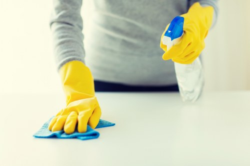 Office cleaning team preparing a workspace in E2