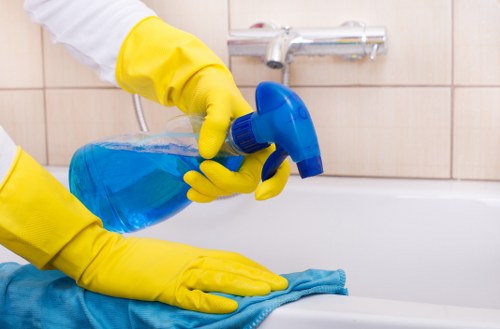 Professional cleaner working in a typical E2 apartment